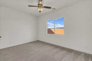 Unfurnished room with carpet flooring and a ceiling fan