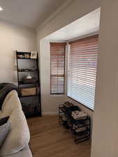 Living area with dark wood-style floors, a textured ceiling, and ornamental molding