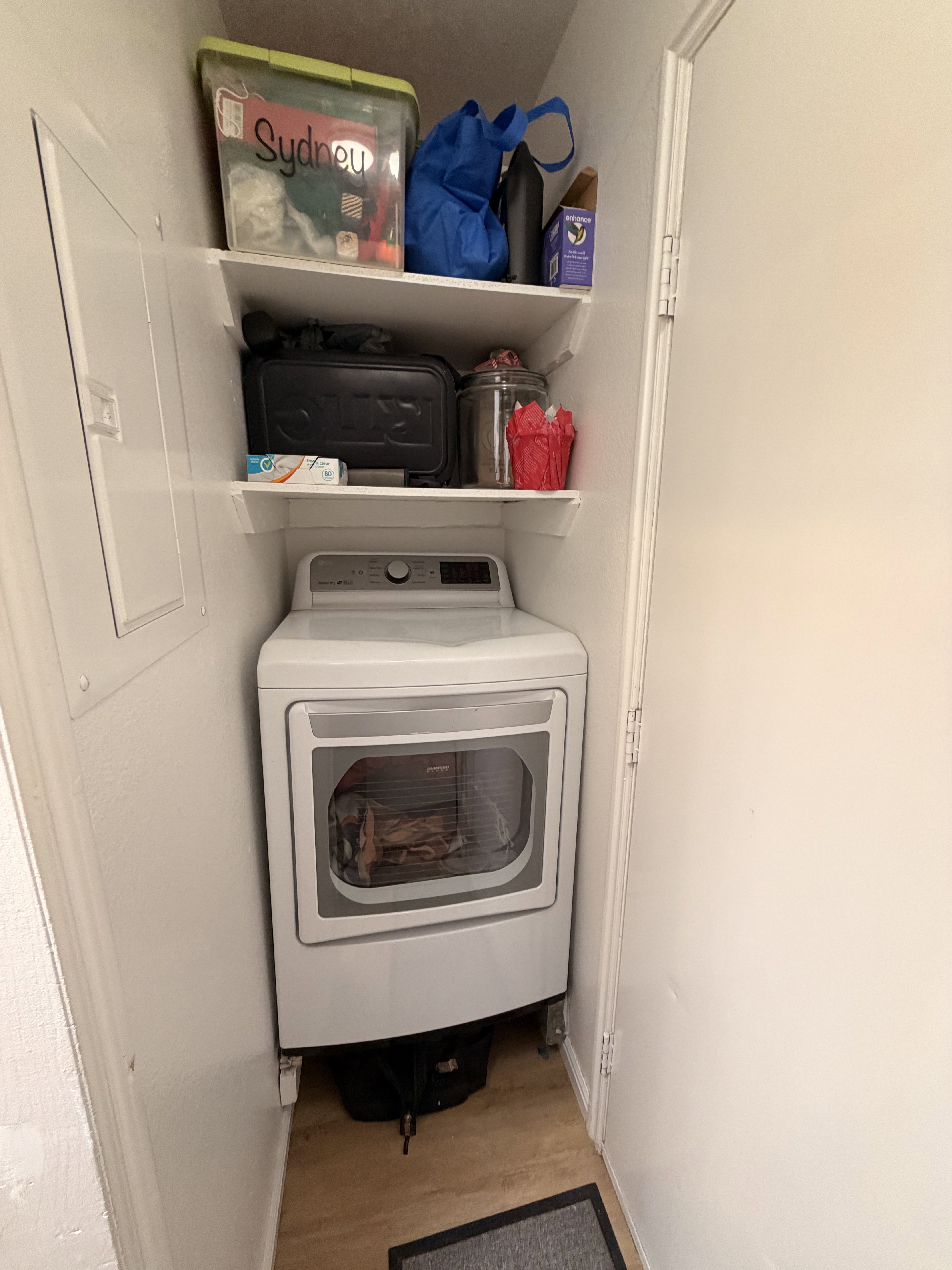 Laundry room with washer / dryer and light wood-style floors