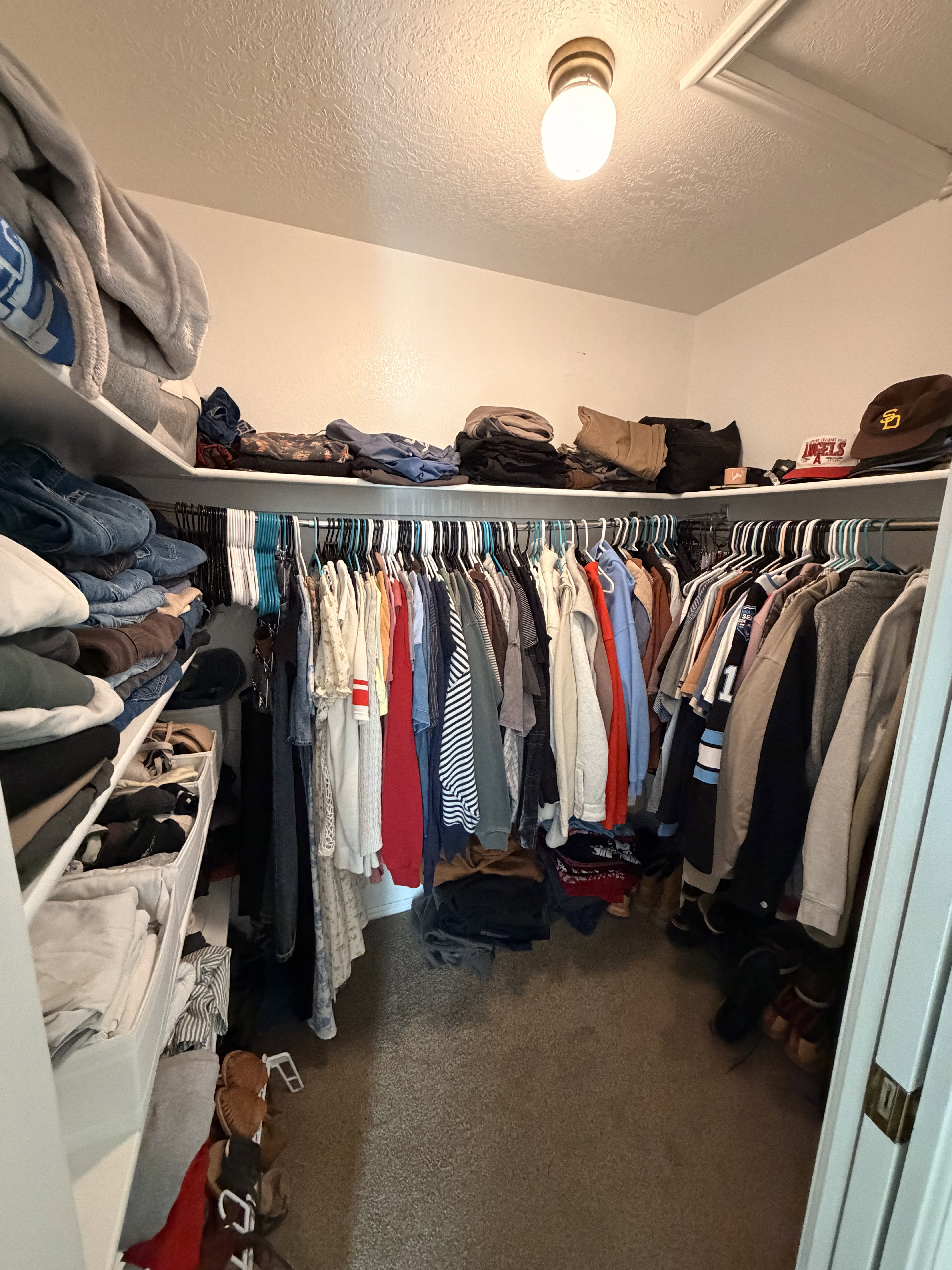 Walk in closet featuring dark carpet