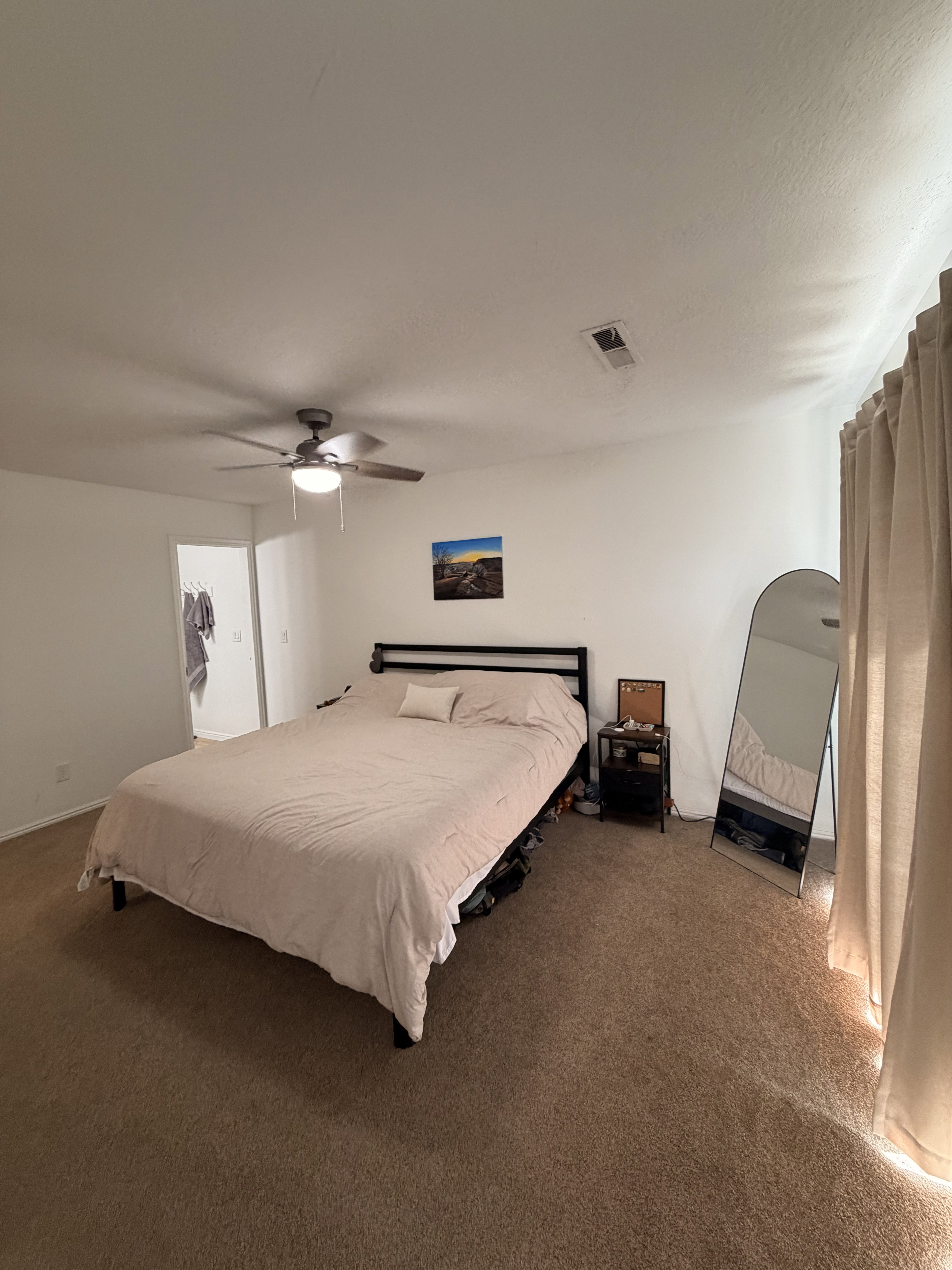 Bedroom featuring dark carpet and ceiling fan