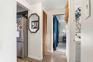 Corridor with light wood finished floors and baseboards