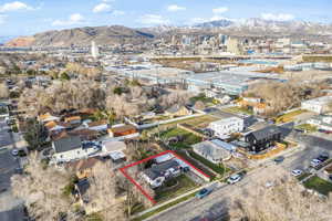 Aerial overview of property's location with property boundaries highlighted and a mountainous background