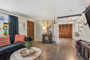 Living room with hardwood / wood-style floors and baseboards