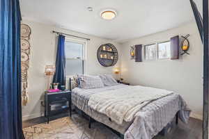 Bedroom featuring baseboards and wood finished floors