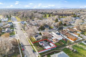 Aerial view of residential area featuring property boundaries highlighted and a mountain backdrop