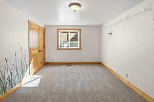 Unfurnished bedroom featuring a closet and carpet floors