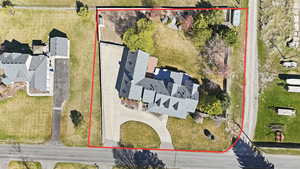 Aerial view of property and surrounding area featuring property parcel outlined