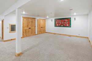 Finished basement with carpet floors and baseboards