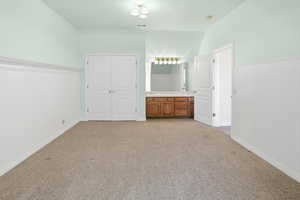 Unfurnished bedroom featuring light carpet and a closet