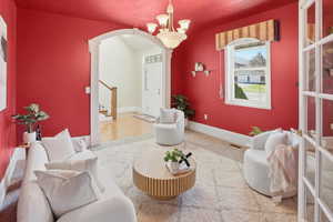Sitting room featuring arched walkways and hanging lights