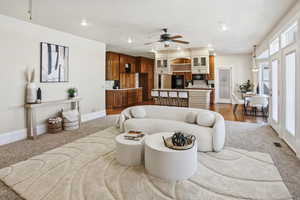 Carpeted living area featuring recessed lighting and a ceiling fan