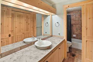 Full bathroom featuring vanity and shower / bathtub combination with curtain