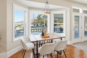 Dining area with light wood-style floors and baseboards