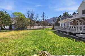 View of yard with a deck with mountain view
