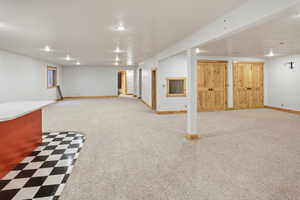 Finished below grade area featuring light carpet and recessed lighting