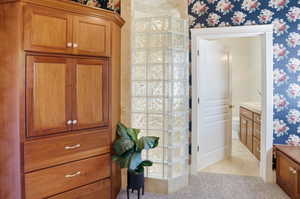 Primary Suite Full bath featuring vanity, light colored carpet, and light tile patterned flooring
