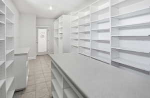 Spacious Pantry featuring light tile patterned floors