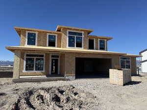 Property in mid-construction with stucco siding and a porch