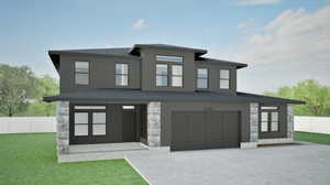 View of front of property featuring stone siding, an attached garage, and driveway