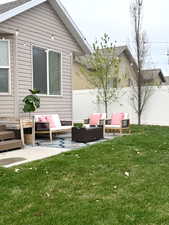 Back of house with outdoor lounge area, a patio, and a fenced backyard