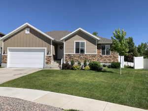 View of front of house with a garage, concrete driveway, board and batten siding, stone siding, and roof with shingles