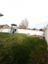 Fenced backyard with a playground