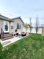 Back of property with an outdoor lounge area, a fenced backyard, a wooden deck, and a patio