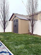 View of shed featuring a fenced backyard
