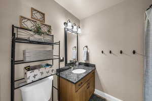 Bathroom with a textured wall and vanity