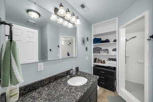 Bathroom with vanity and a shower stall