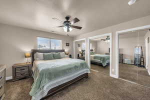 Bedroom featuring multiple closets, a ceiling fan, and dark colored carpet