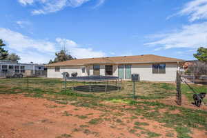 Back of property featuring a trampoline