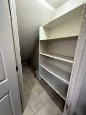 Hall featuring light marble finish flooring