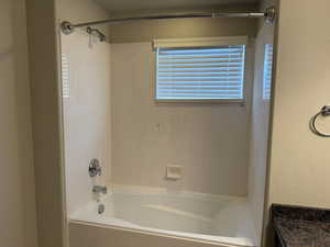 Bathroom with shower / tub combination and vanity