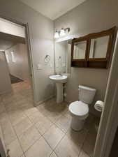 Half bathroom featuring toilet and baseboards