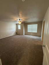 Unfurnished room with carpet, a textured ceiling, and ceiling fan