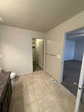 Bathroom featuring vanity, a textured ceiling, and light colored carpet