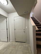 Foyer entrance featuring stairway and a textured ceiling