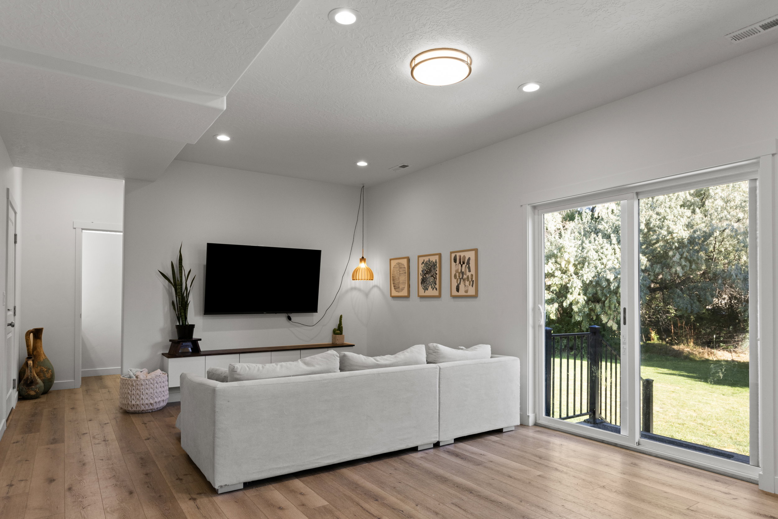 Living area featuring light wood-type flooring, recessed lighting, and a textured ceiling