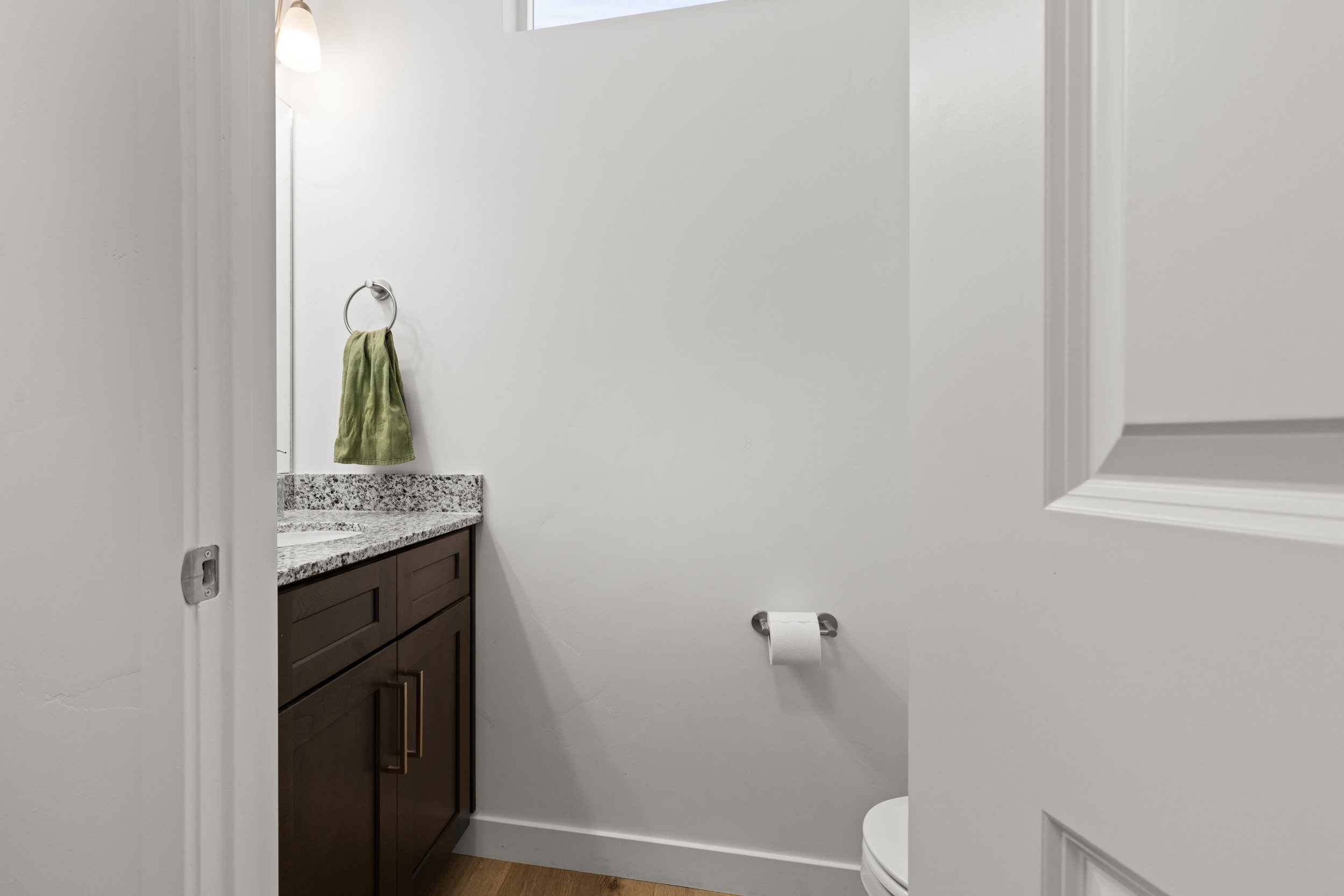 Half bathroom with vanity and light wood-style floors