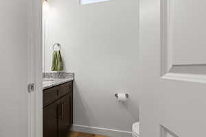 Half bathroom with vanity and light wood-style floors
