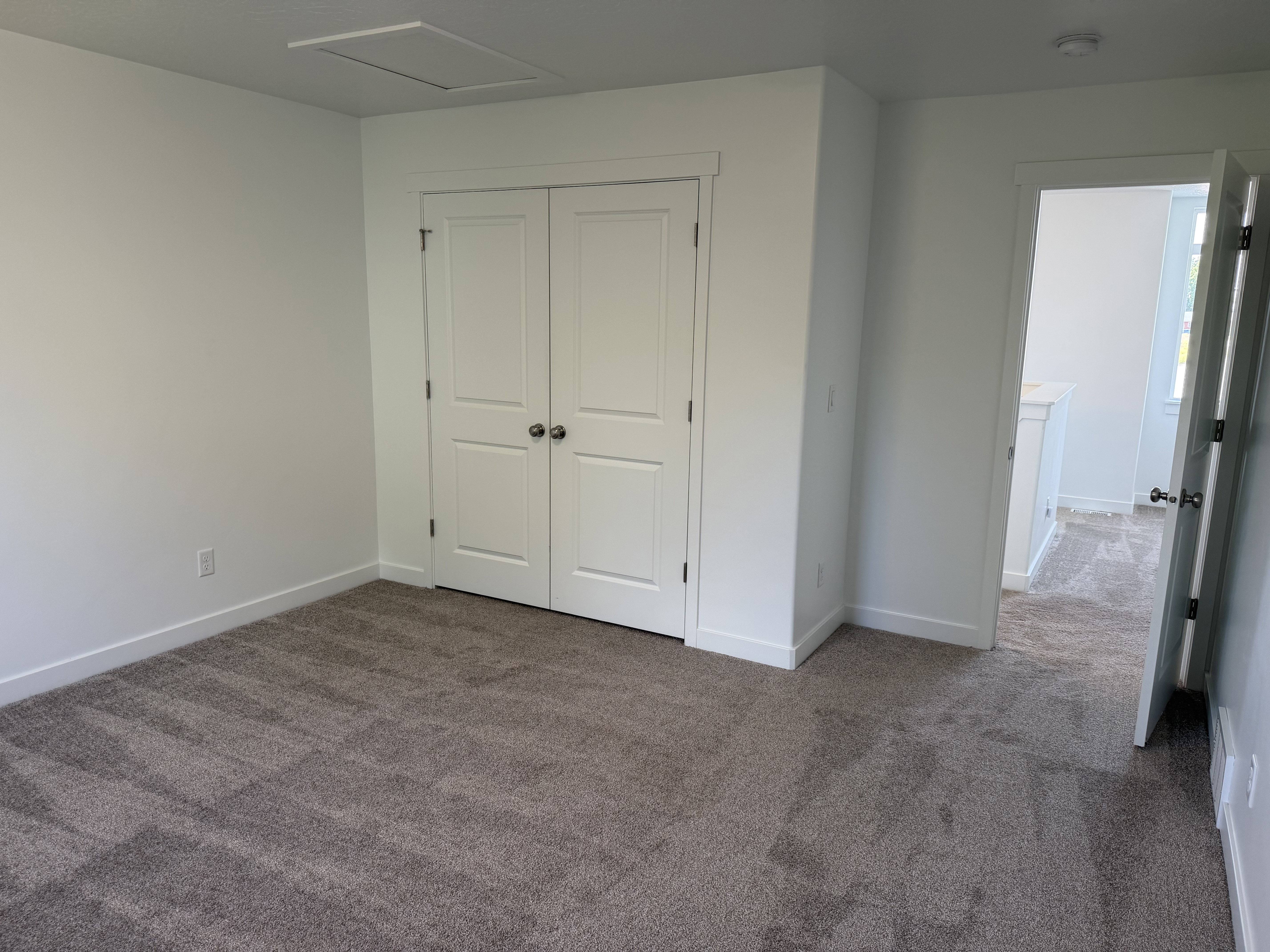 Neutral-toned carpeting paired with crisp white walls