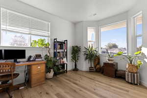 Office area featuring light wood-style flooring and healthy amount of natural light