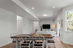 Dining area featuring light wood-type flooring, recessed lighting, and a textured ceiling