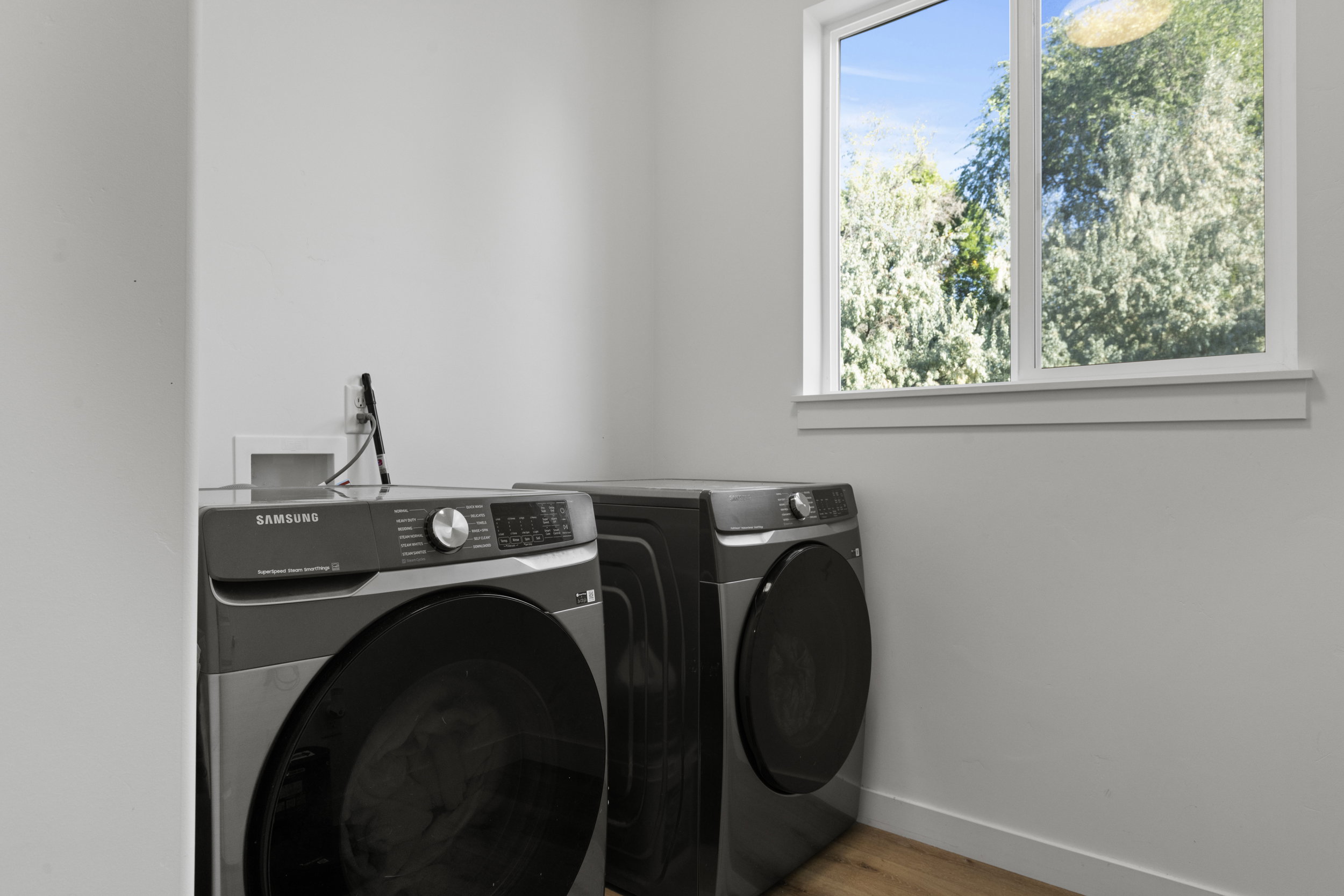 Laundry area featuring light wood-style floors and washer and dryer