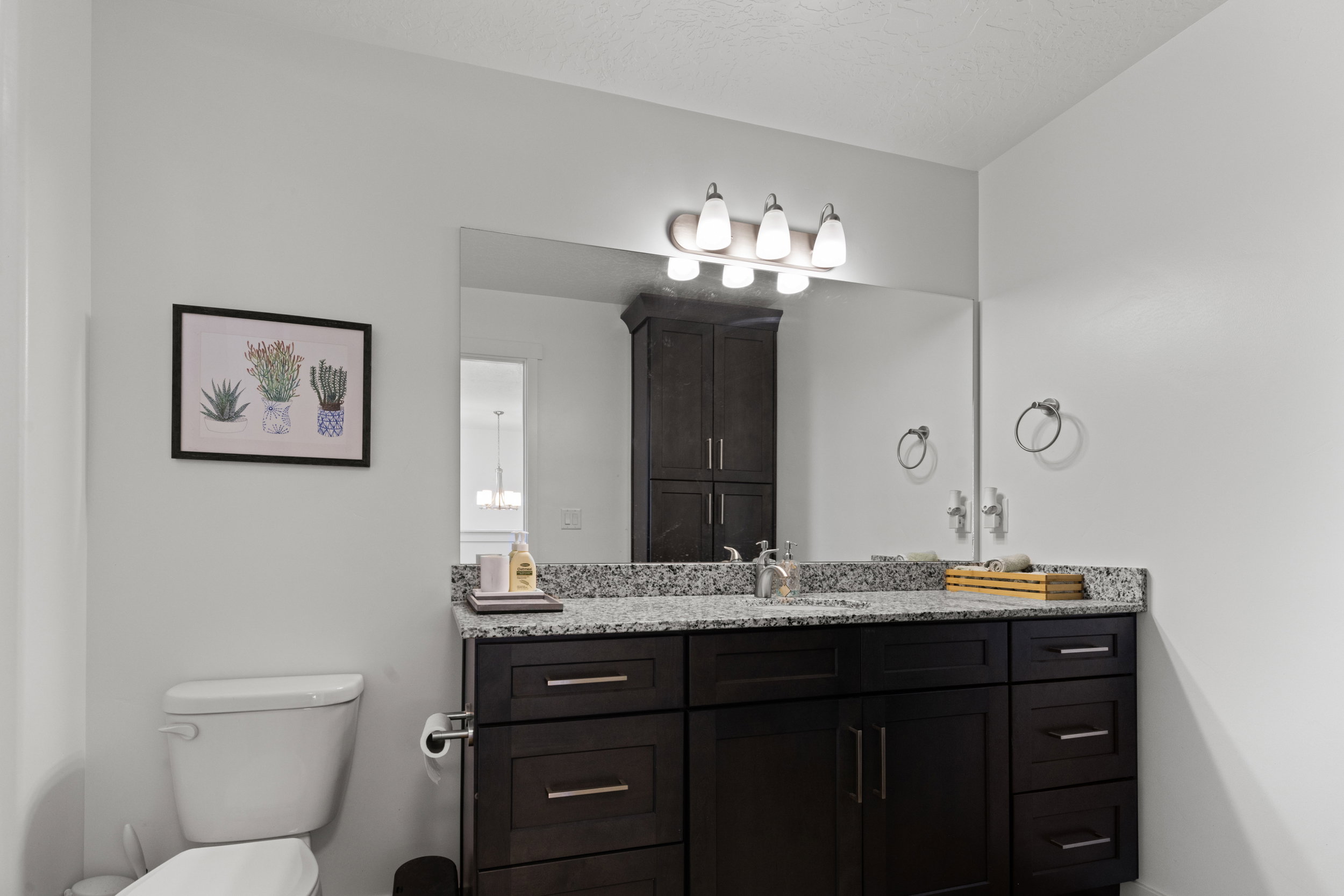 Half bathroom featuring vanity and toilet