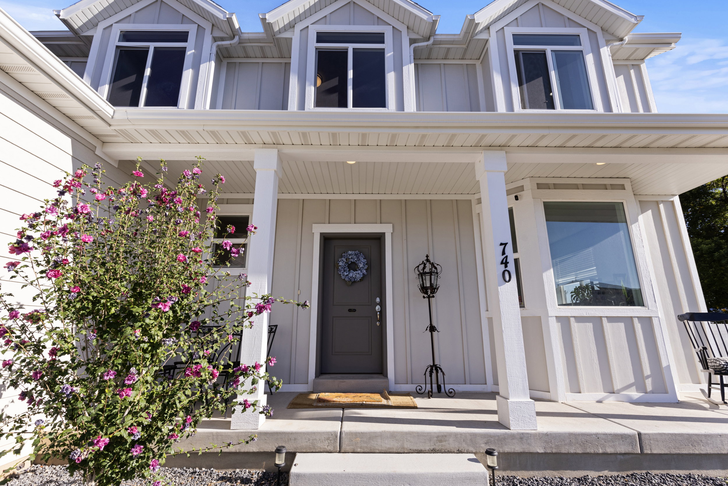 View of exterior entry featuring board and batten siding and a porch