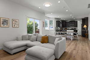 Living area with recessed lighting and light wood finished floors