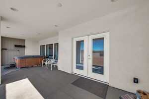 View of patio / terrace featuring french doors and a hot tub